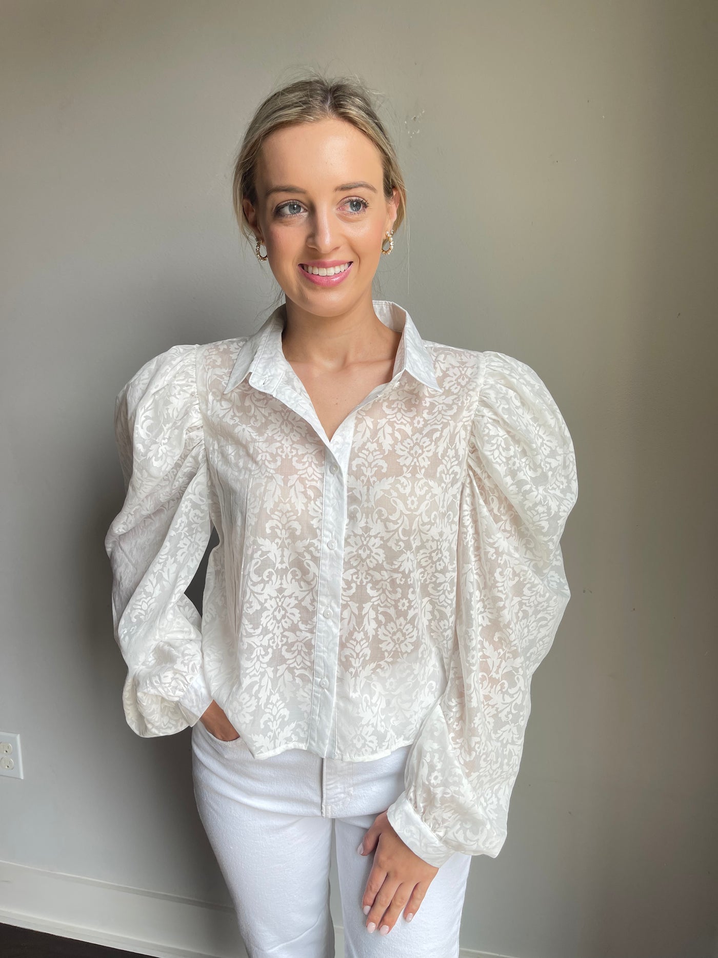 The Flora Top from Shop Silvs is a white button down puff sleeve top that adds a touch of elegance to any outfit. 