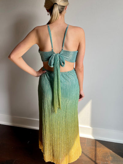 This green and yellow beach dress features a gorgeous bow tie detail and open back.