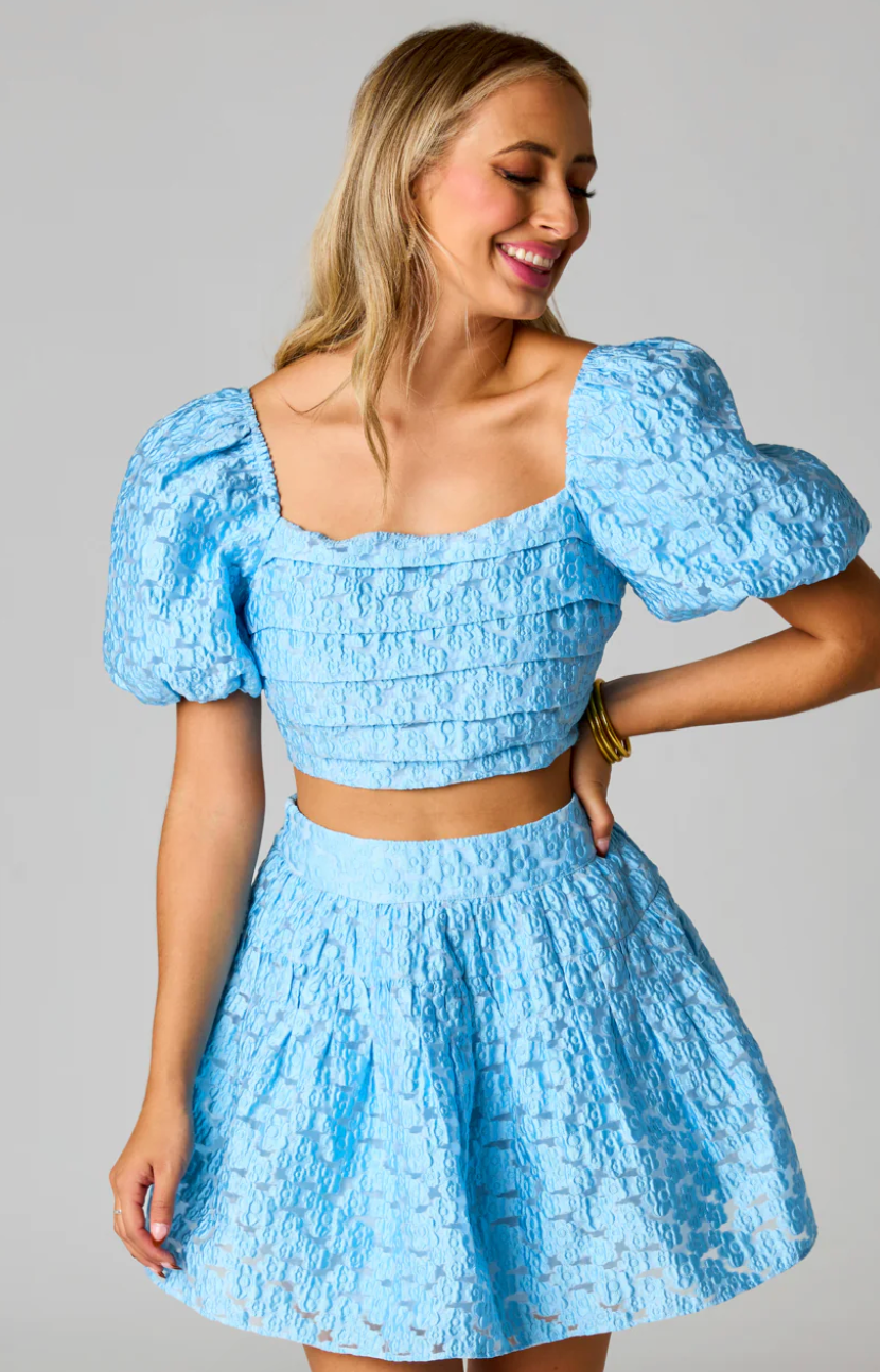 The BuddyLove Cutie Two-Piece Set sold by Shop Silvs is a blue puff sleeve mini skirt set by designer favorite BuddyLove. 