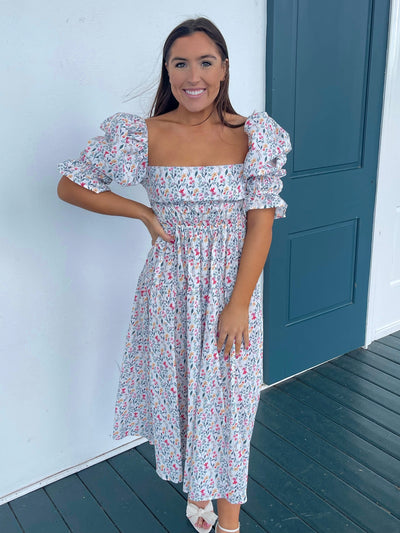 The Lay Dress from Shop Silvs is a floral print open-backed dress with puff sleeves that's both sweet and sassy.