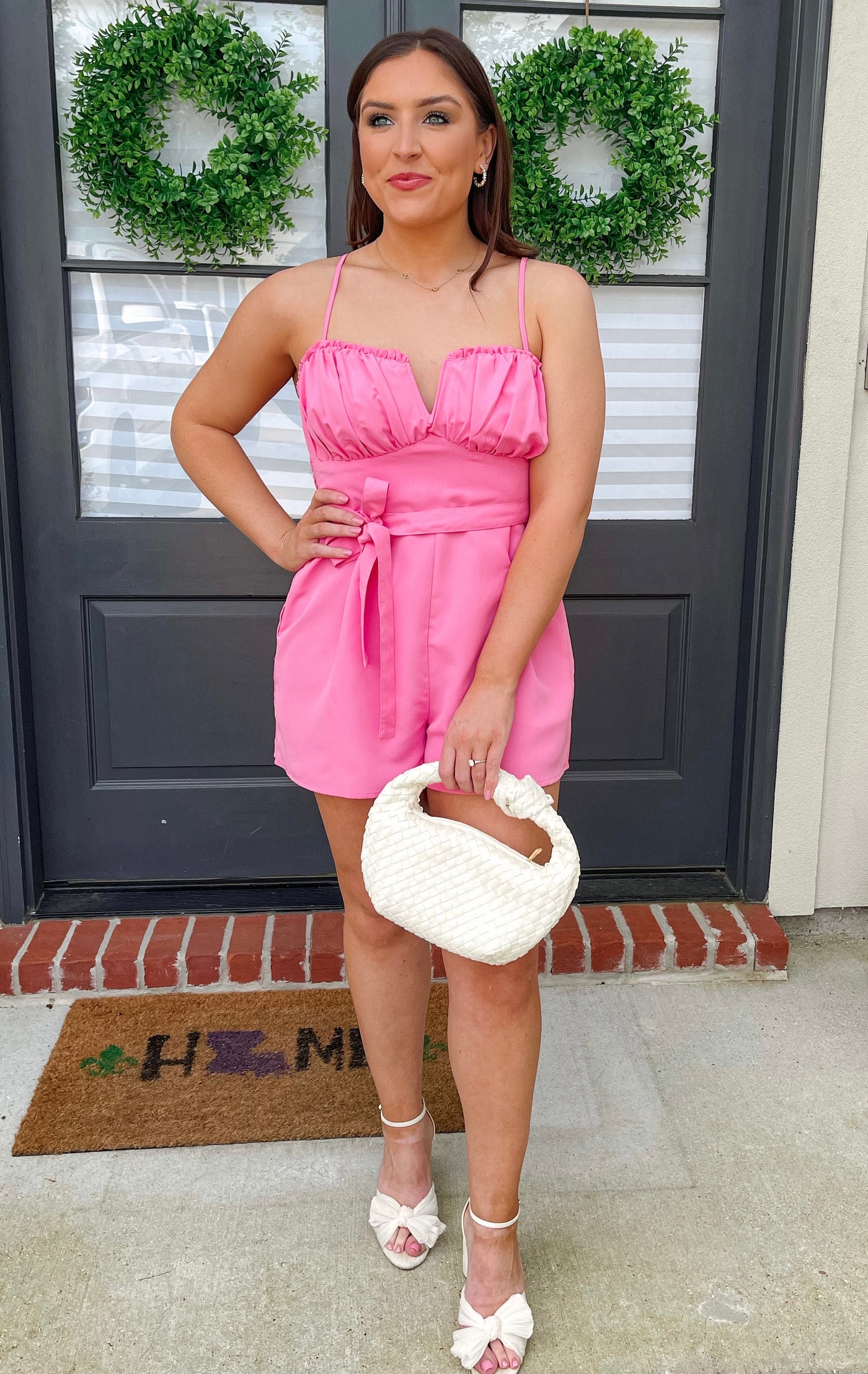 Pair this boutique-style hot pink romper with heels and our woven bag for the perfect look. 