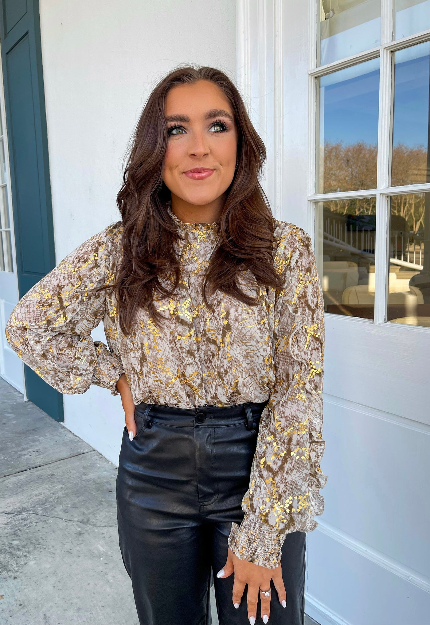 This gold blouse with smocked cuffs looks fabulous with black leather pants.