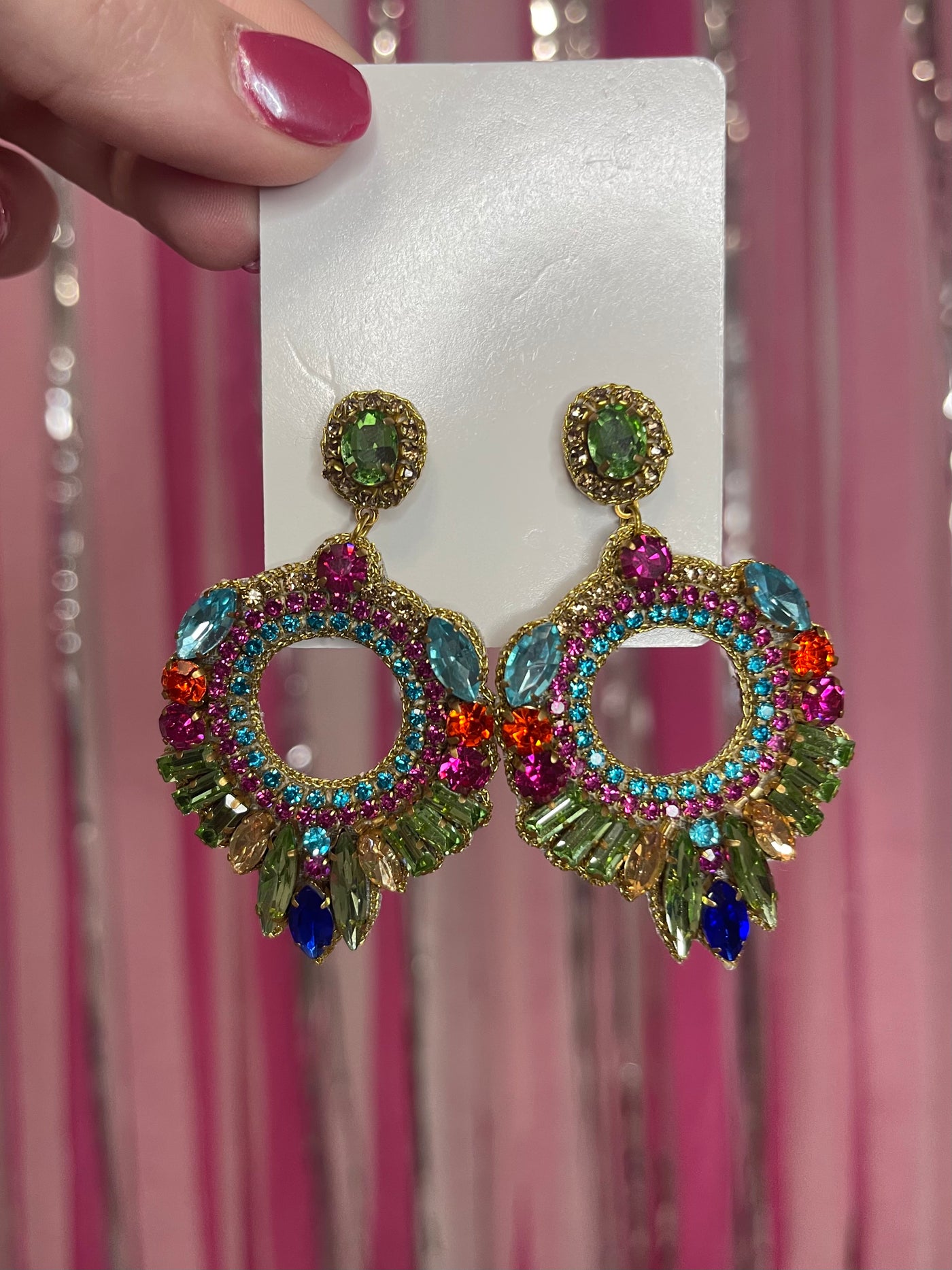 The Jewel Statement Earrings from Shop Silvs feature a variety of different colored jewels in an intricate circle design. 