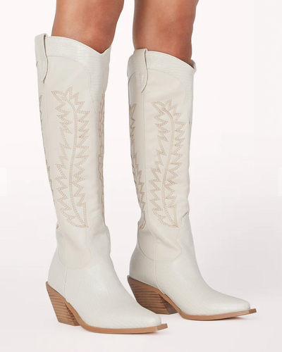 These white knee high cowboy boots from Shop Silvs pair well with just about any outfit.