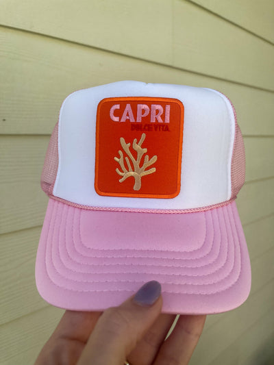 This colorful pink and orange trucker hat reads "Capri Dolce Vita" and embodies the vibrant, "sweet life" spirit of the Mediterranean island of Capri. 