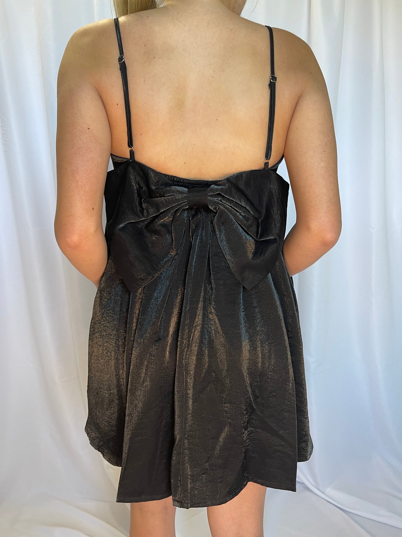 This black satin baby doll dress from Shop Silvs has an accented bow tie on the back.