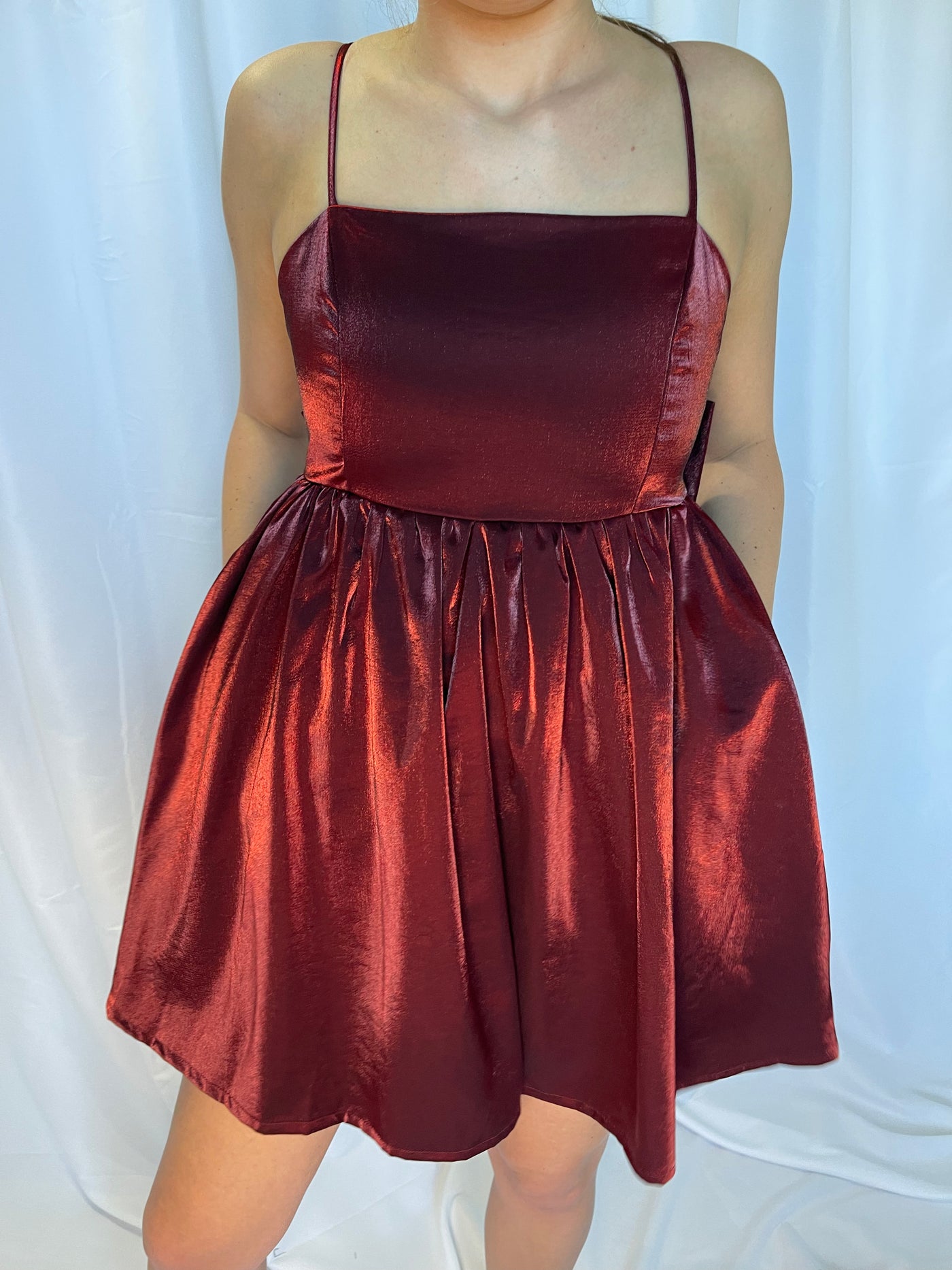 The Baby Doll Bow Dress from Shop Silvs is a burgundy baby doll dress.
