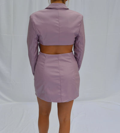 The Lily Dress from Shop Silvs is a lilac leather mini dress that pairs well with ankle booties.