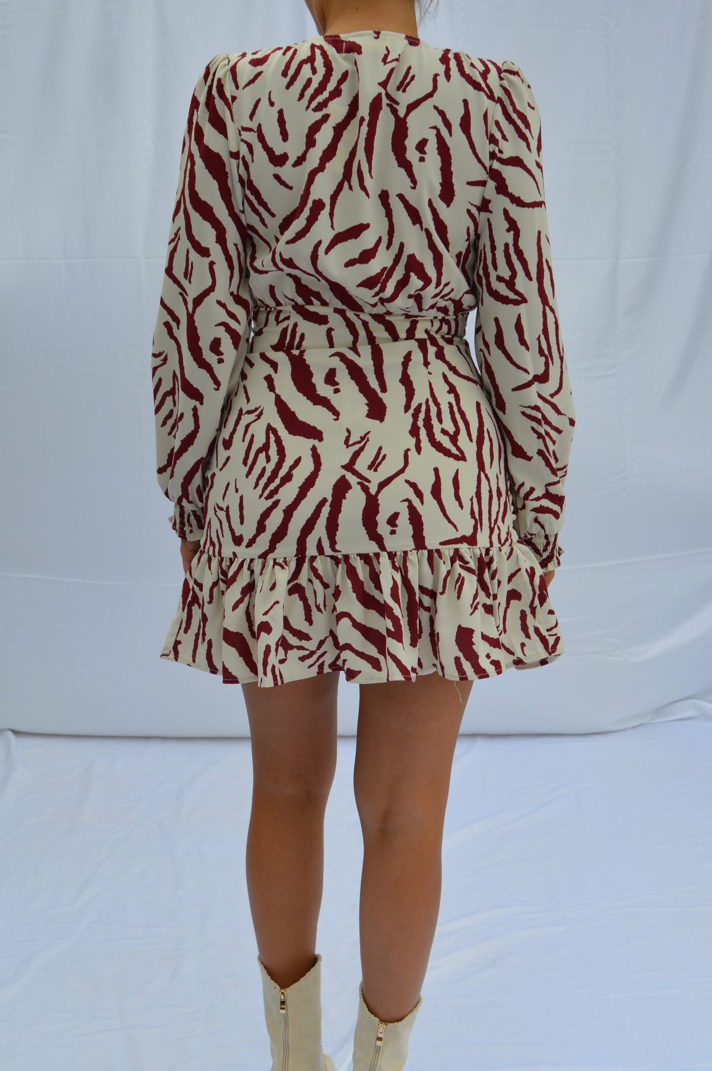 This red and white tiger print dress features a ruffled hemline.